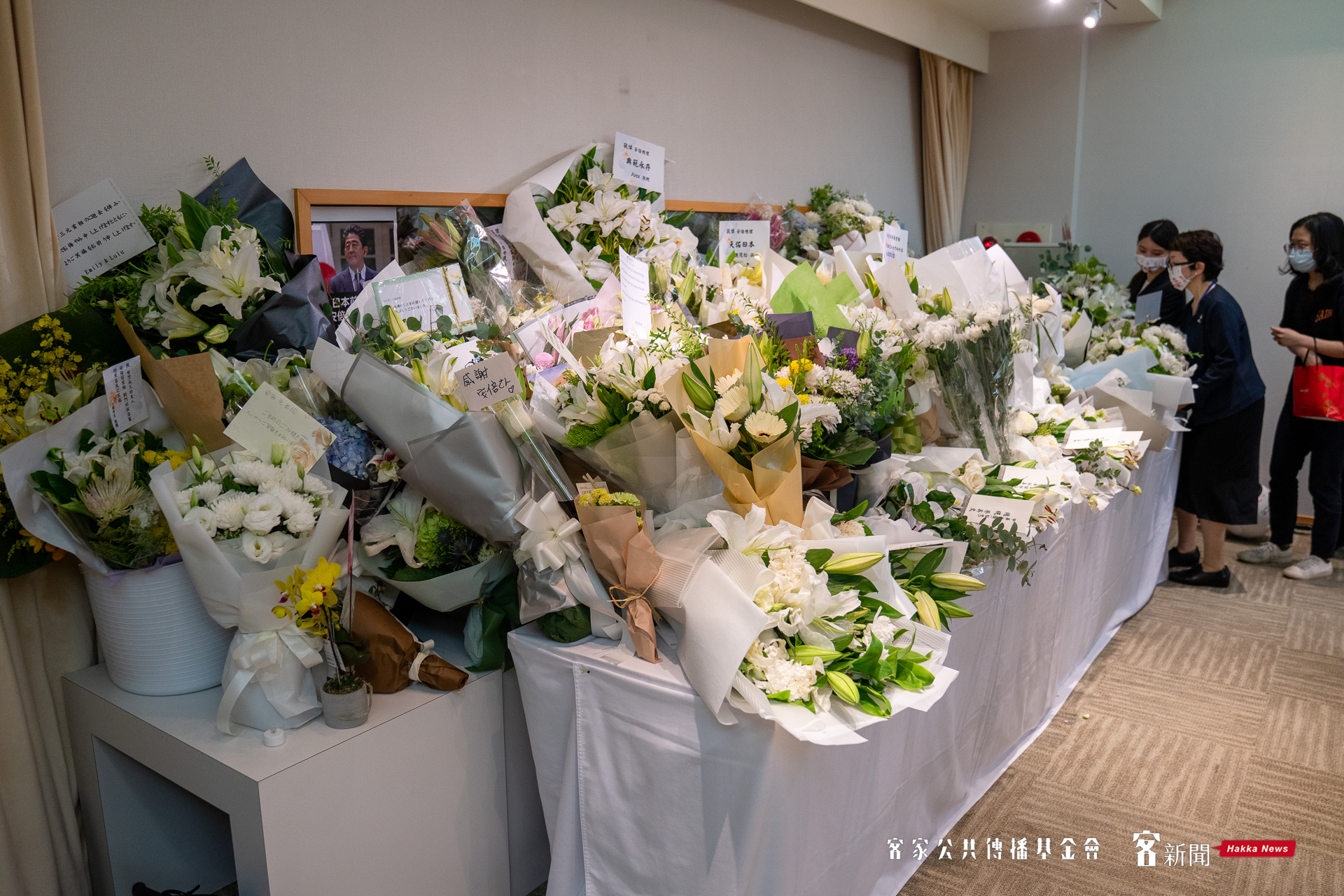 悼念的鮮花擺滿大廳桌面。范修語攝