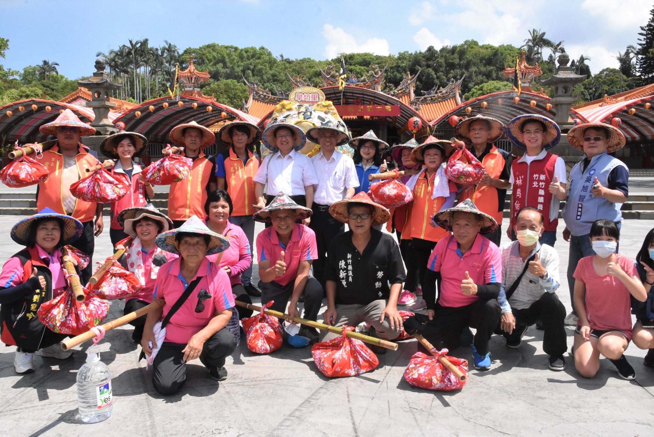 每年千人挑擔活動是義民祭的重頭戲之一,重現了過往客家先民挑擔奉飯情景。圖為新竹縣長楊文科(後排左5)、客委會副主委范佐銘(後排左6)日前參加挑擔活動。新竹縣府提供