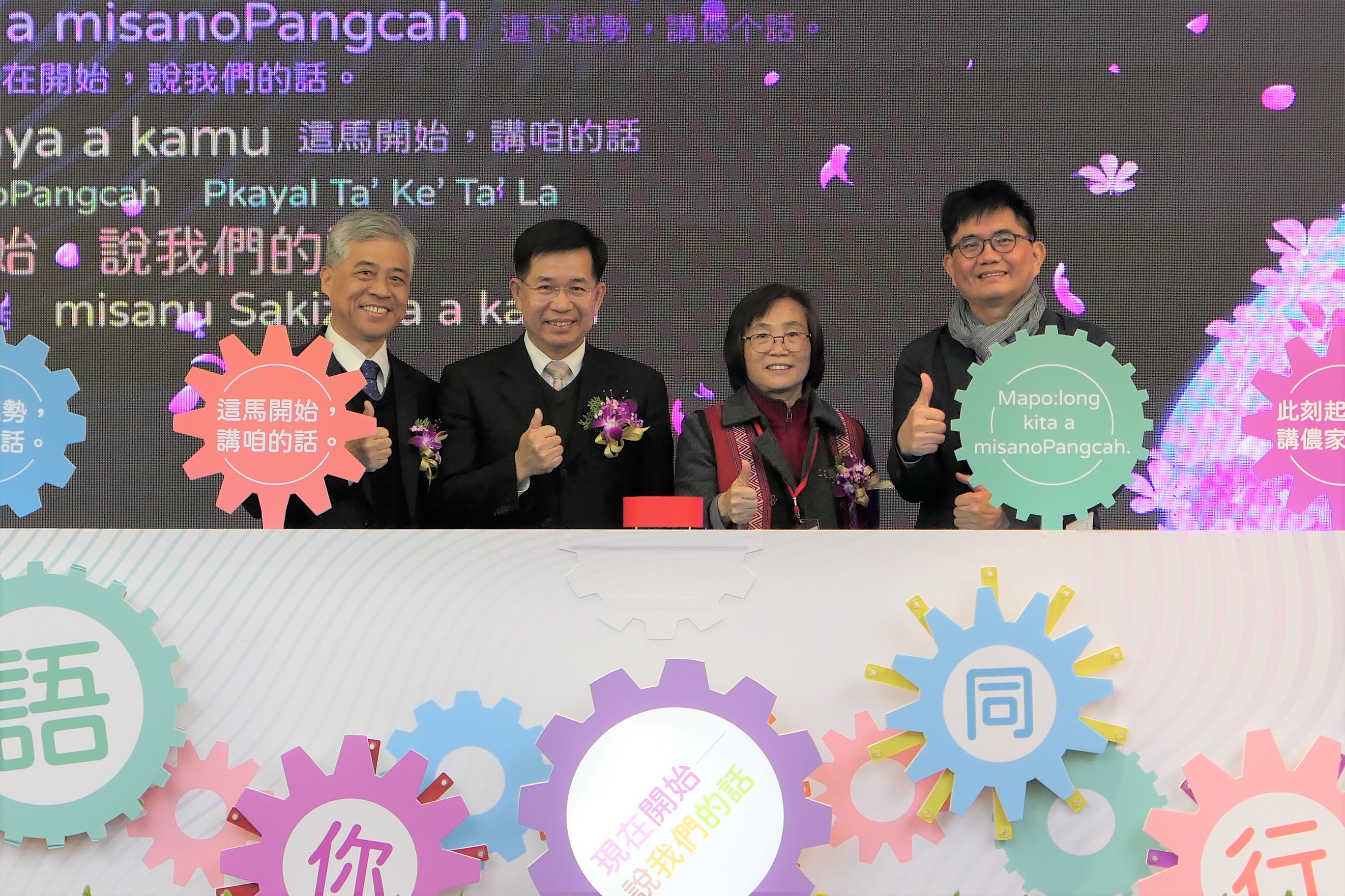 慶祝儀式合影教育部部長潘文忠(左二)、客委會副主委范佐銘(左一)、文化部主任秘書陳登欽(右一),以及原住民族委員會政務副主委林碧霞(右二)齊聚臺上一起將標有客語、holo、馬祖語、原住民族語的宣傳板子,貼上舞臺,邀請大家一起講母語,感受說母語的感動及驕傲!