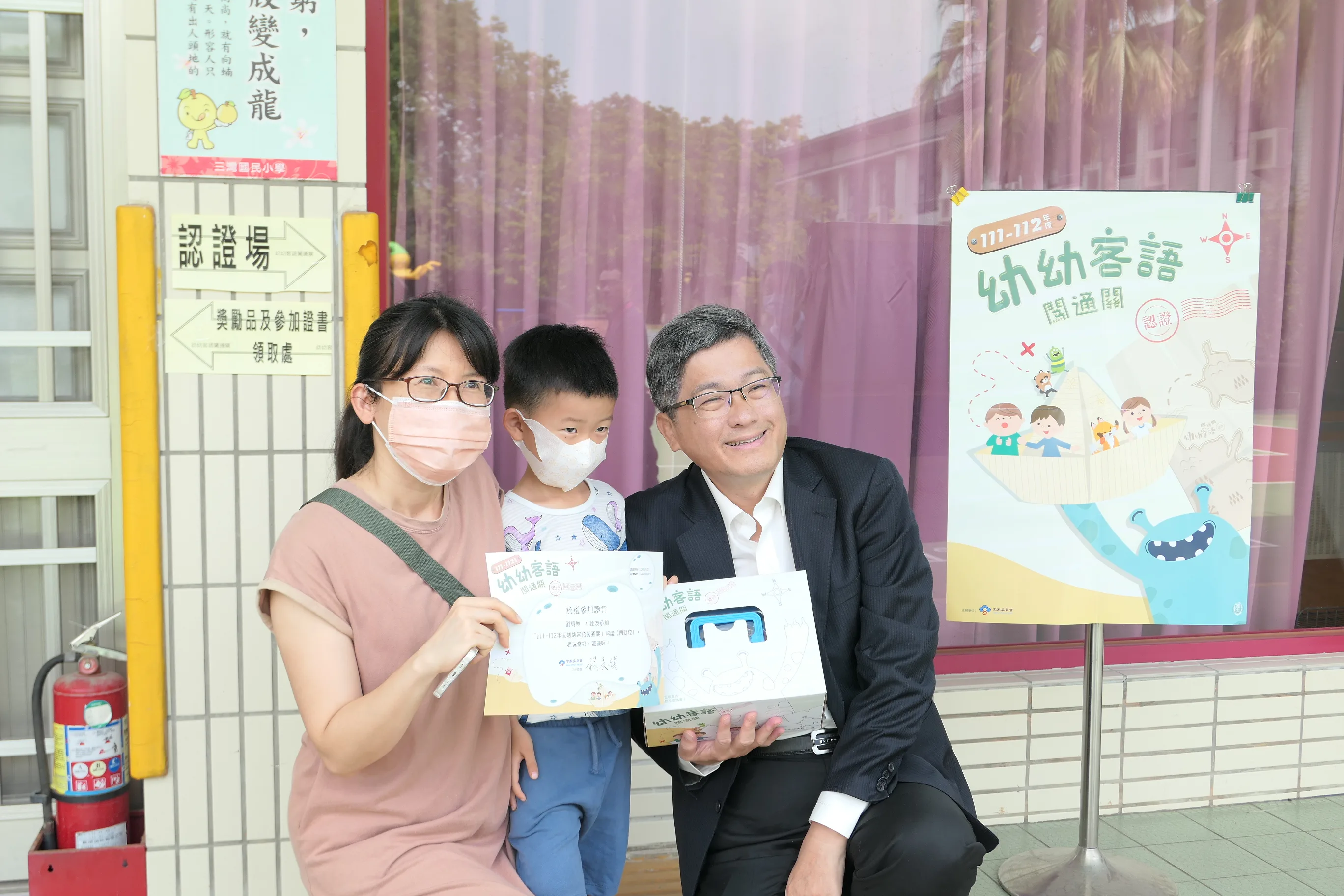 客委會主委楊長鎮(右一)頒發參加證書及獎勵品給完成闖通關的小朋友。客委會提供