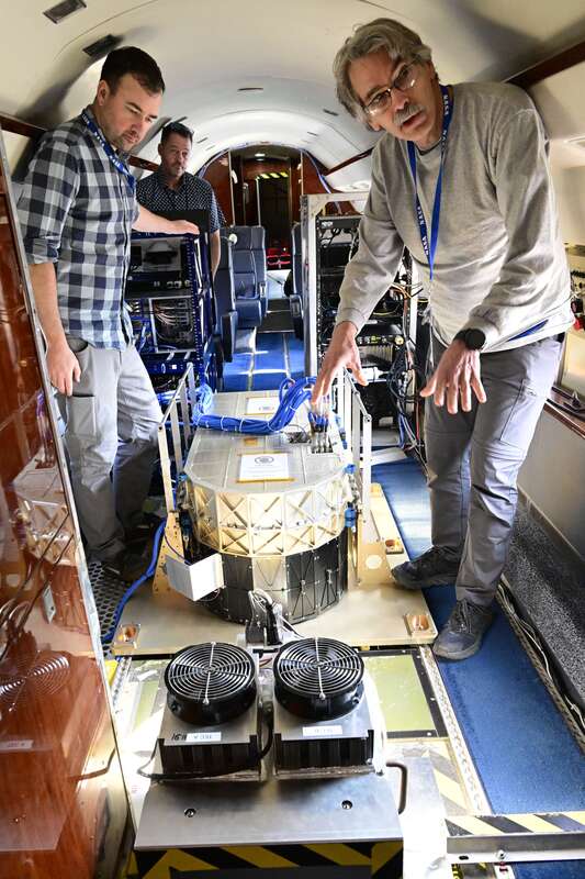 NASA灣流III型飛機機上研究人員解說儀器功能。中央社