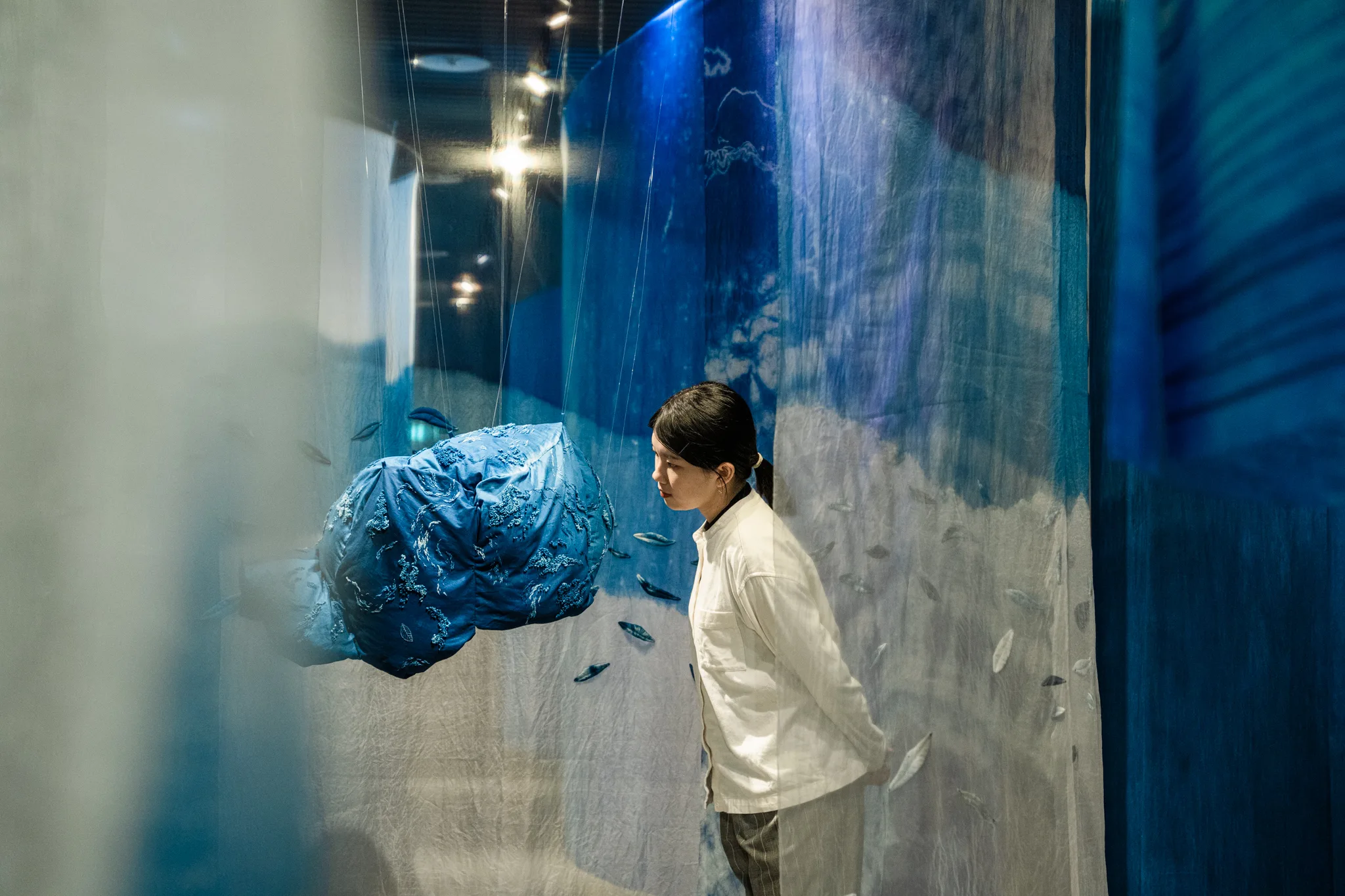 觀展民眾進入工藝媒材與藍染織品相互激盪的展區。新北市客家局提供