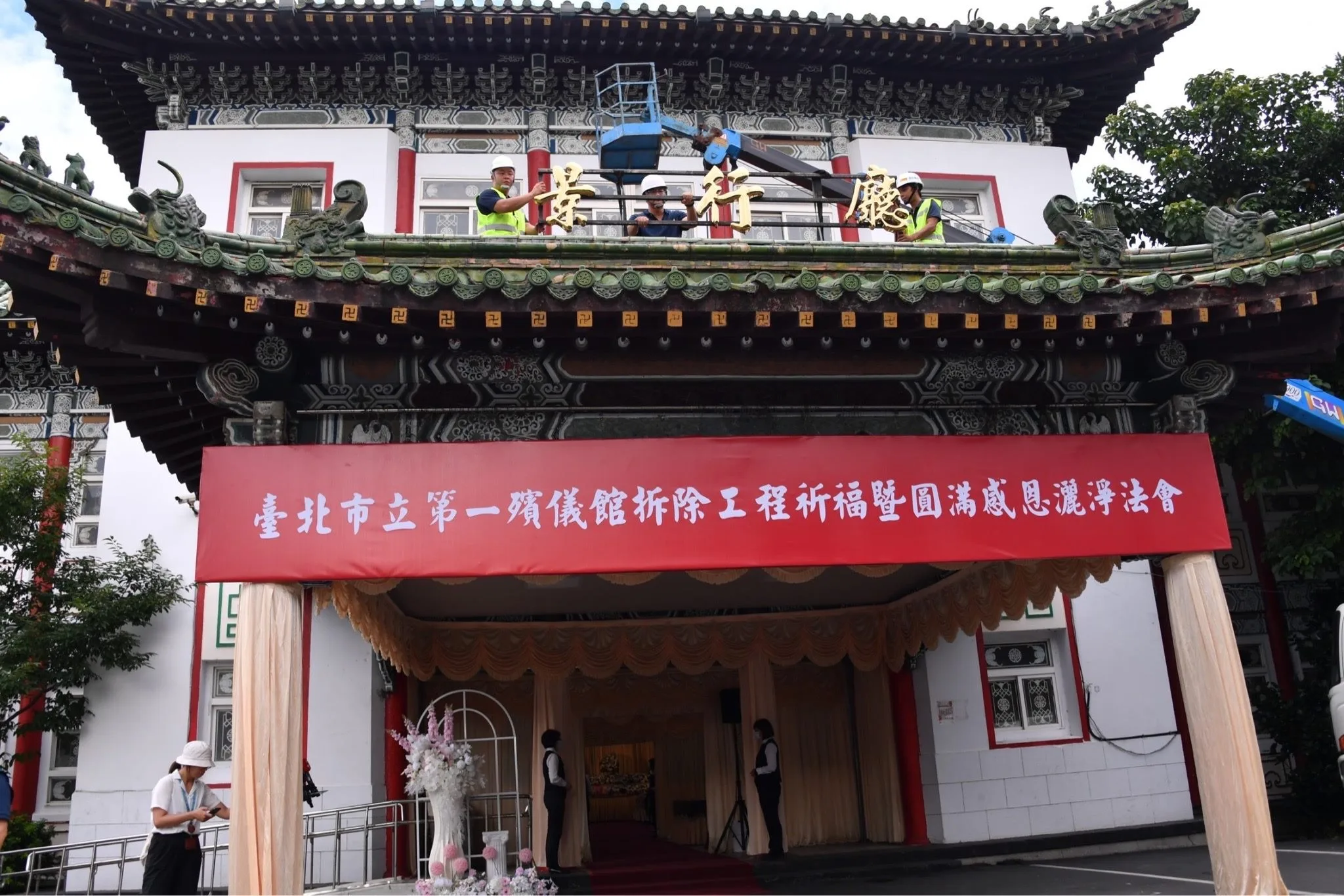 台北市第一殯儀館今謝幕，施工人員將「景行廳」銜牌拆卸。台北市政府提供