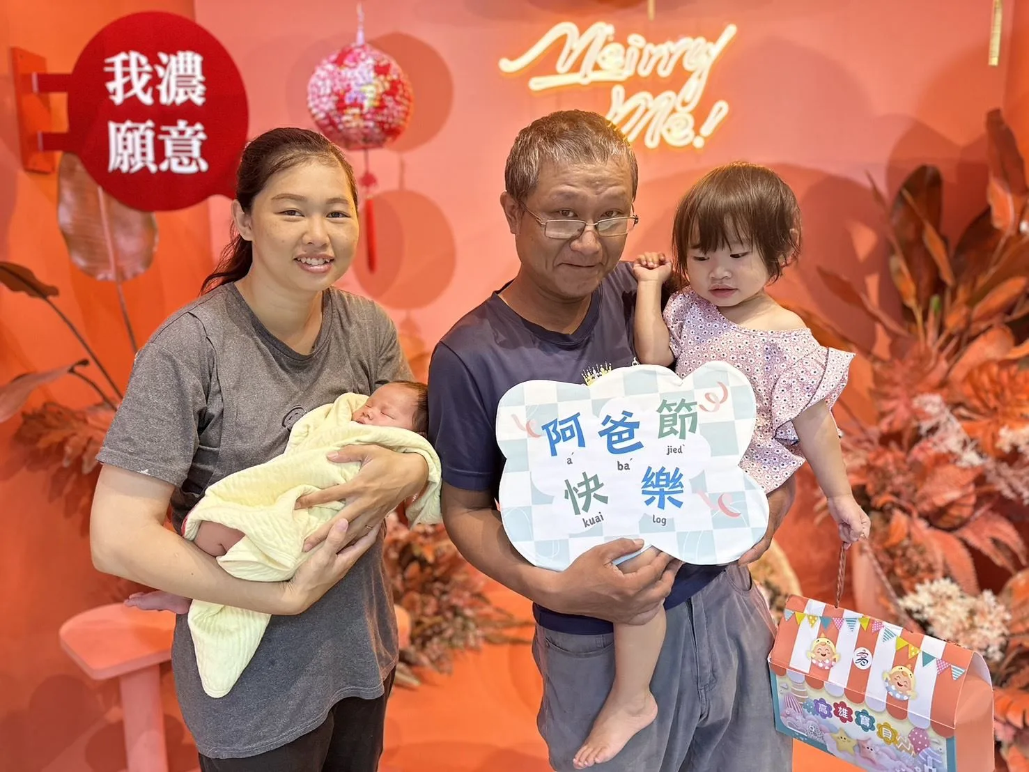 民眾手拿「阿爸節快樂」標語，響應父親節活動。美濃戶政事務所提供