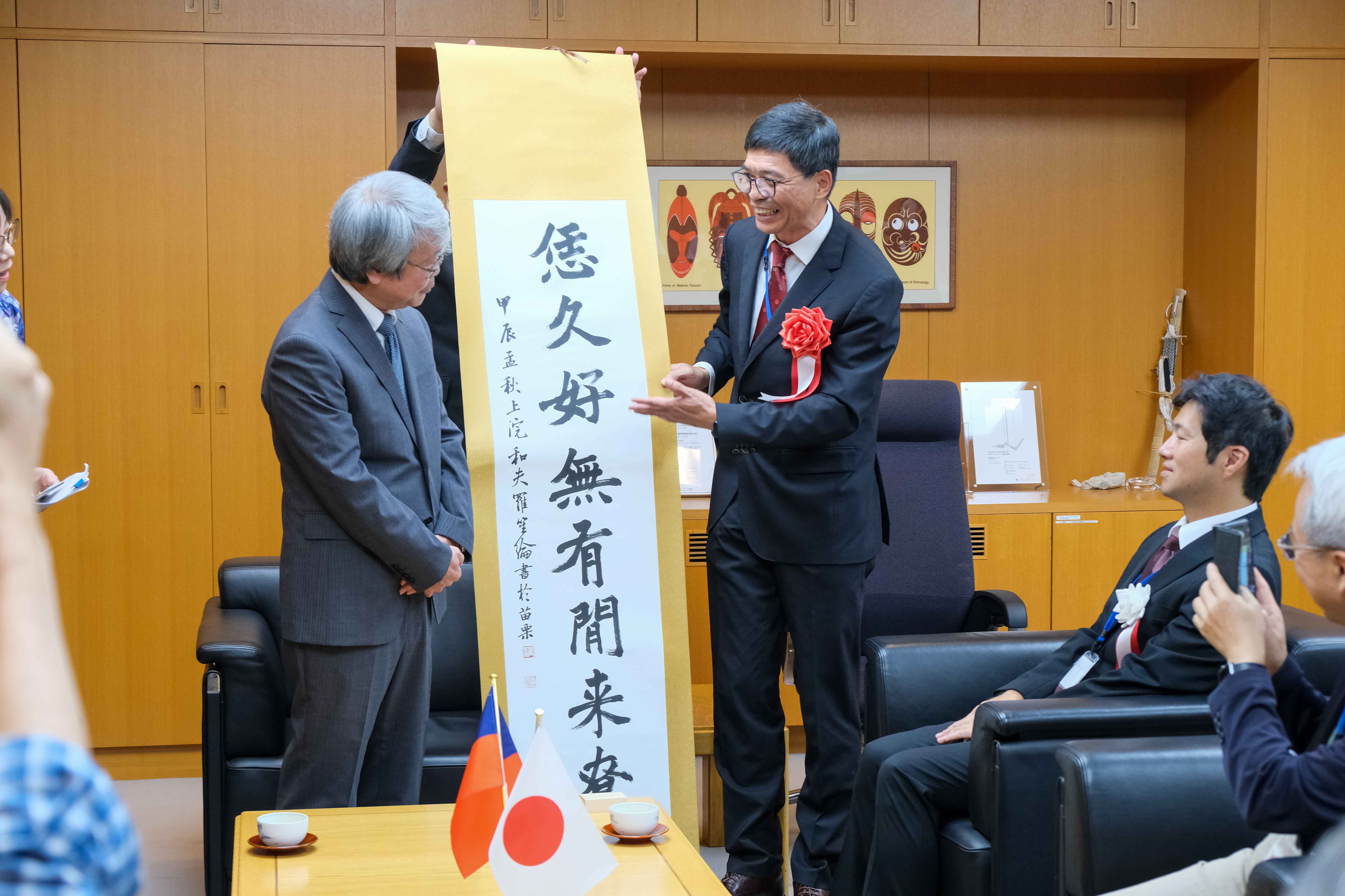 客發中心主任何金樑與學者們拜會民博吉田憲司館長致贈客語書法。客發中心提供