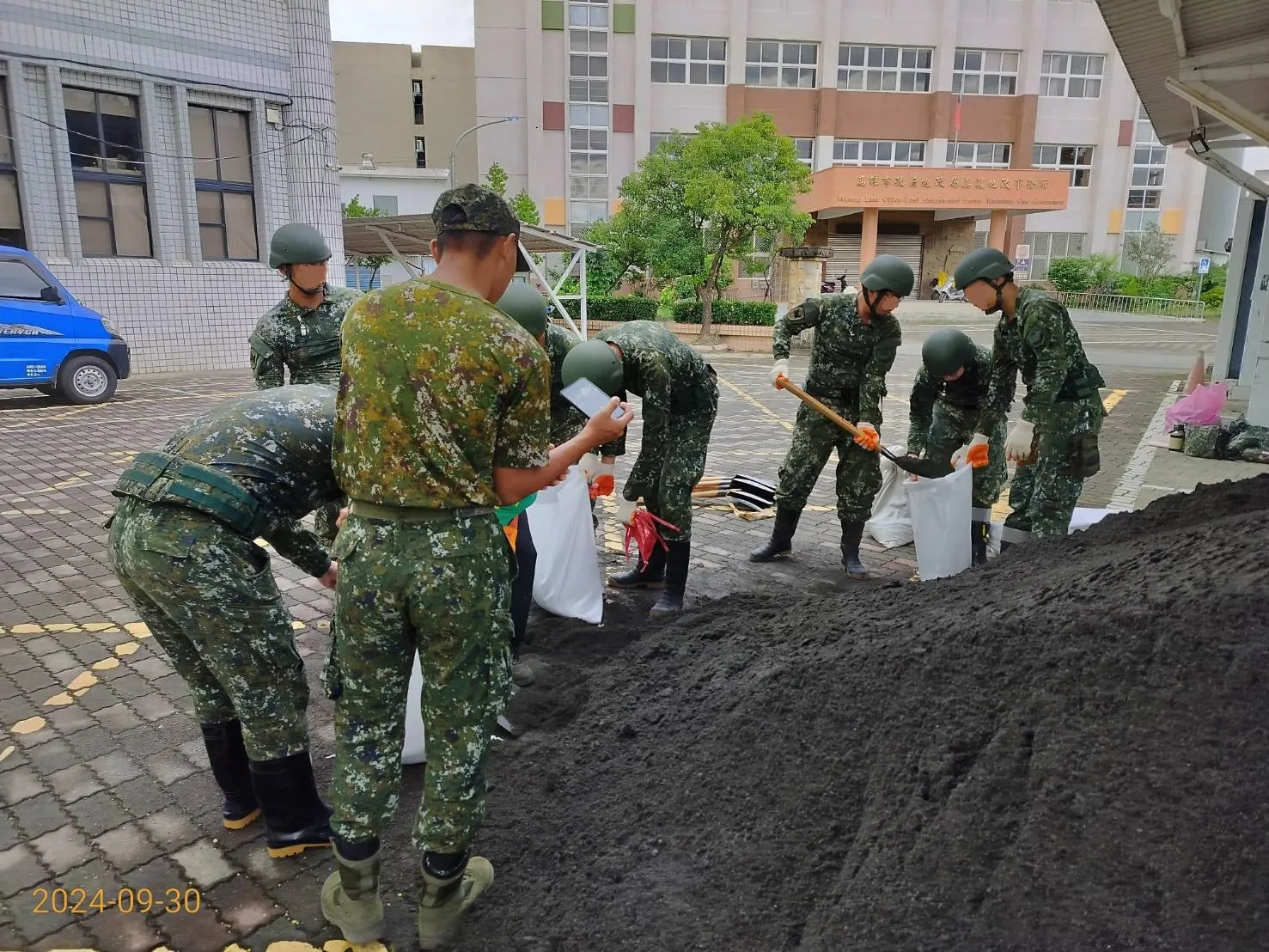 國軍官兵於美濃區公所前，協助民眾填裝沙包。翻攝高雄市美濃區公所臉書