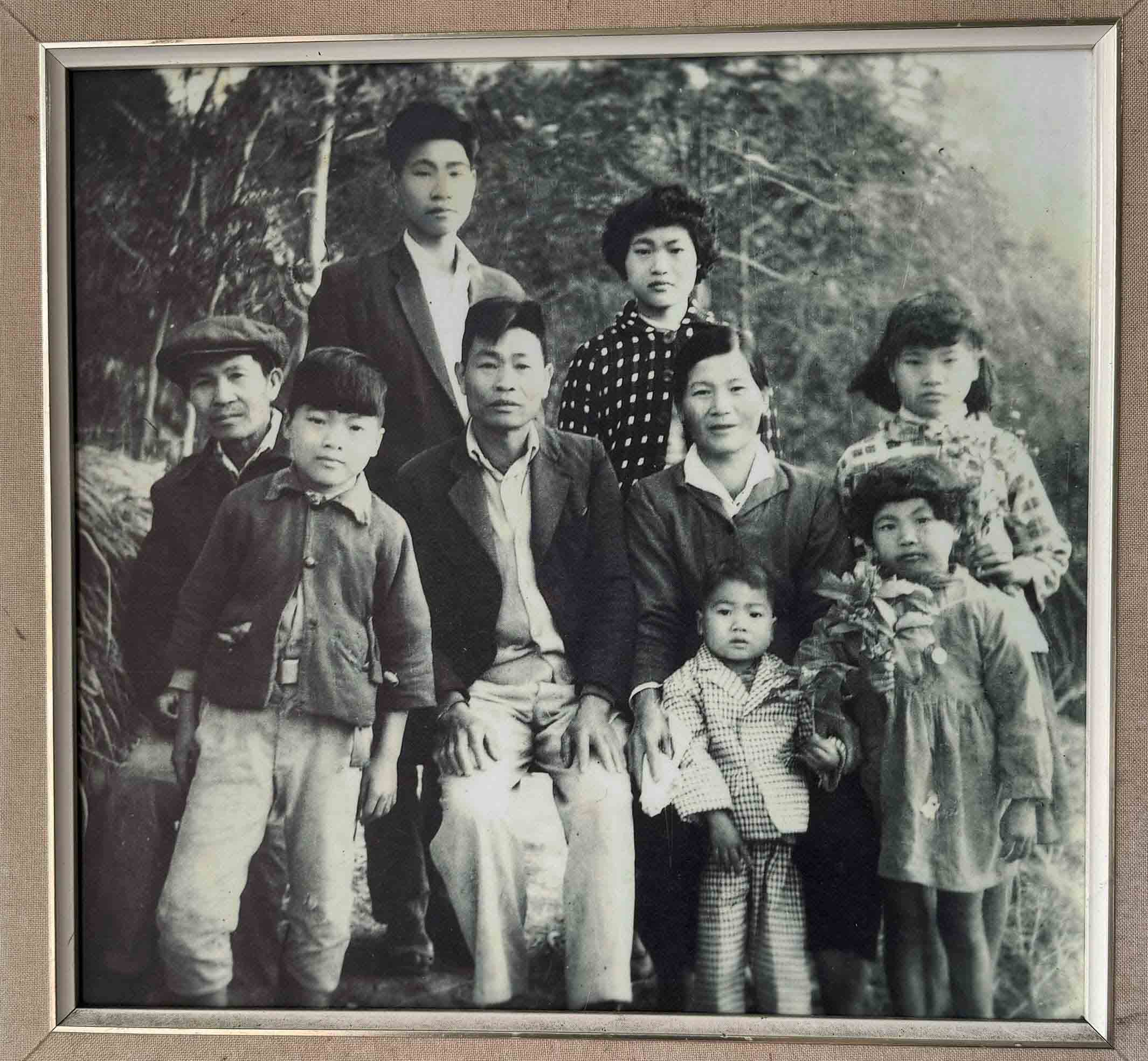 何治郎(後排左一)是腦丁之子,圖為他與三伯何土方(前排左一)、雙親何東炎、陳蓮妹夫婦(前排中)及弟妹們合影。何治郎提供