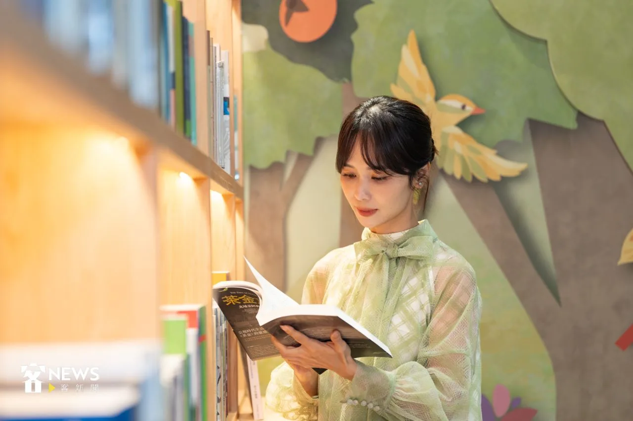 主持人陳明珠沈浸於客家書籍裡，享受閱讀。宋佩遙攝