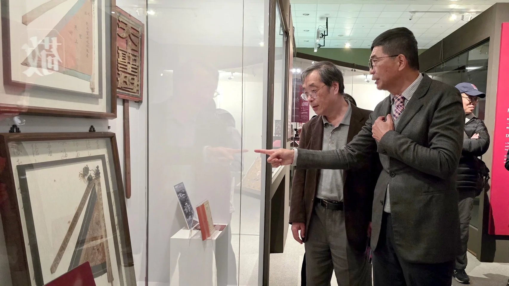 何金樑帶學者們參觀「拼．靚：臺灣客家多重面貌」客家文物聯展，觀賞北港朝天宮進香旗等文物。客發中心提供