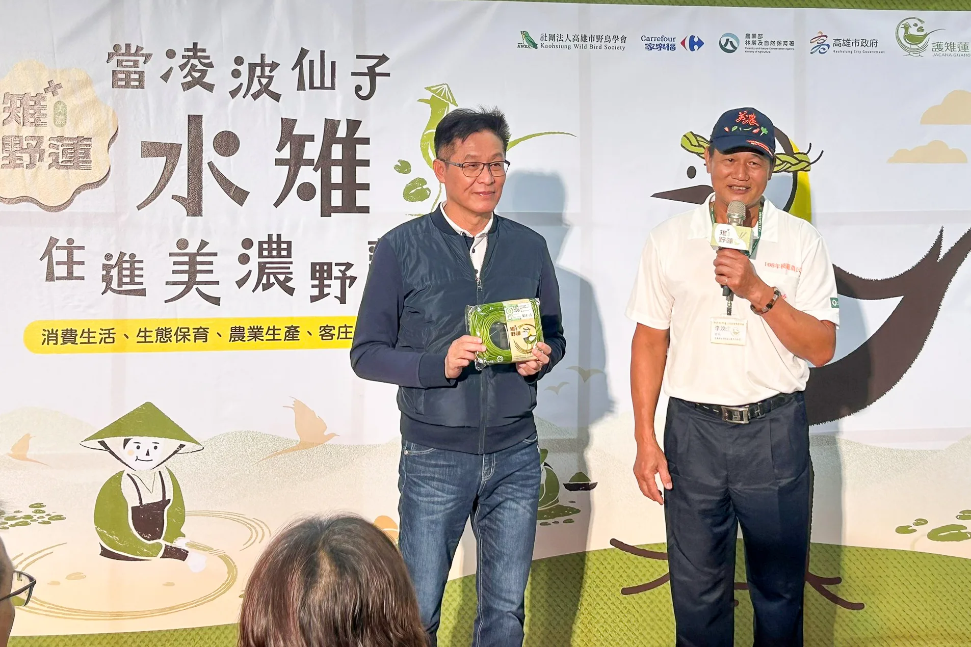 美濃區農會總幹事鍾清輝（左）與美濃區蔬菜產銷班第18班班長李煥生（右）介紹生態友善野蓮。客家委員會提供