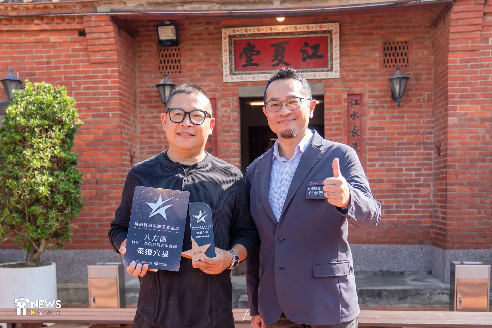 桃園市客家局長范姜泰基(右)頒發六星獎牌給八方園餐廳老闆黃帥欽(左)。李宥妍攝