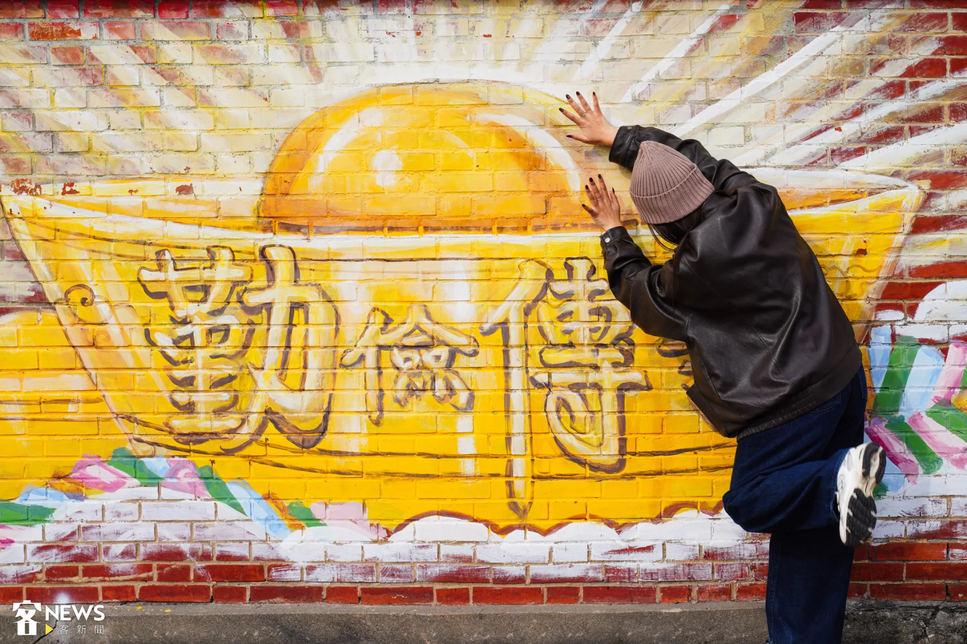 記者也秉持著勤儉傳家的精神與彩繪牆合照,希望他今年能賺大錢。朱愷元攝