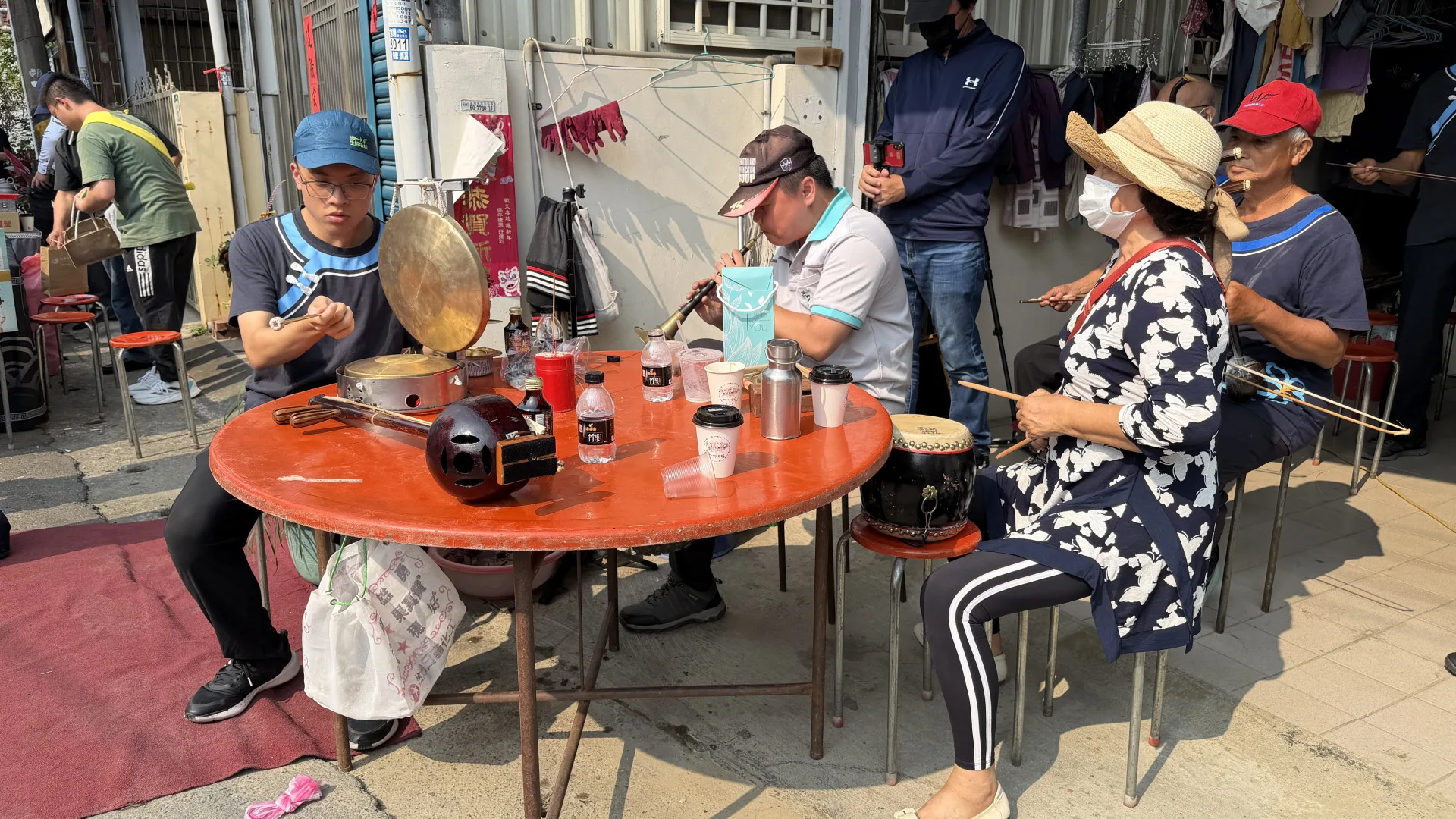 吳梓銜（左）、潘俊名（中）、蘇櫻菊（右）三人在温福仁告別式上以客家八音作場為老師送行。李慧宜攝