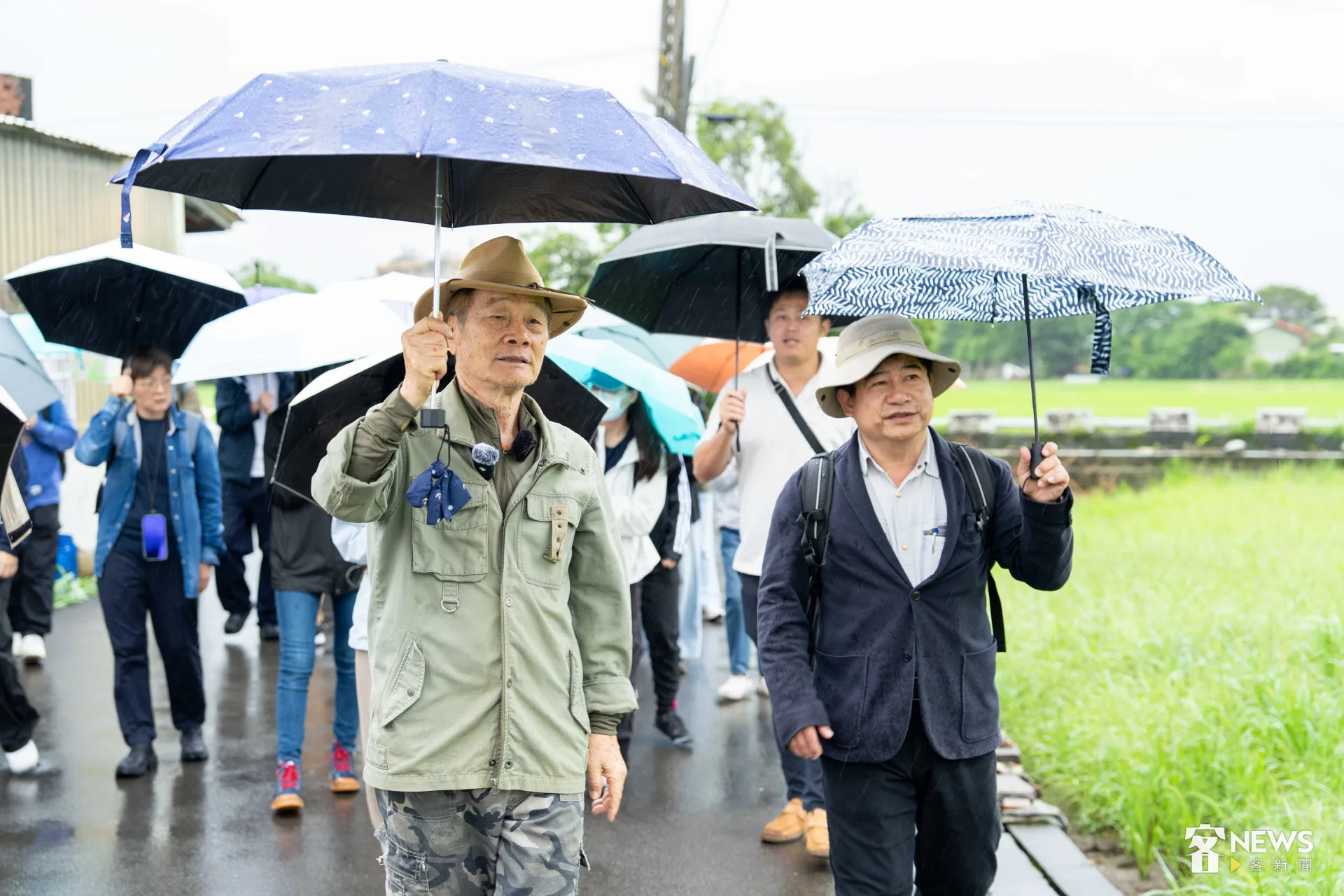 走讀當天下起陣雨，徐仁修（中）帶領客傳會董事長宋廷棟（右）及客傳會同仁深度認識芎林客庄。朱愷元攝
