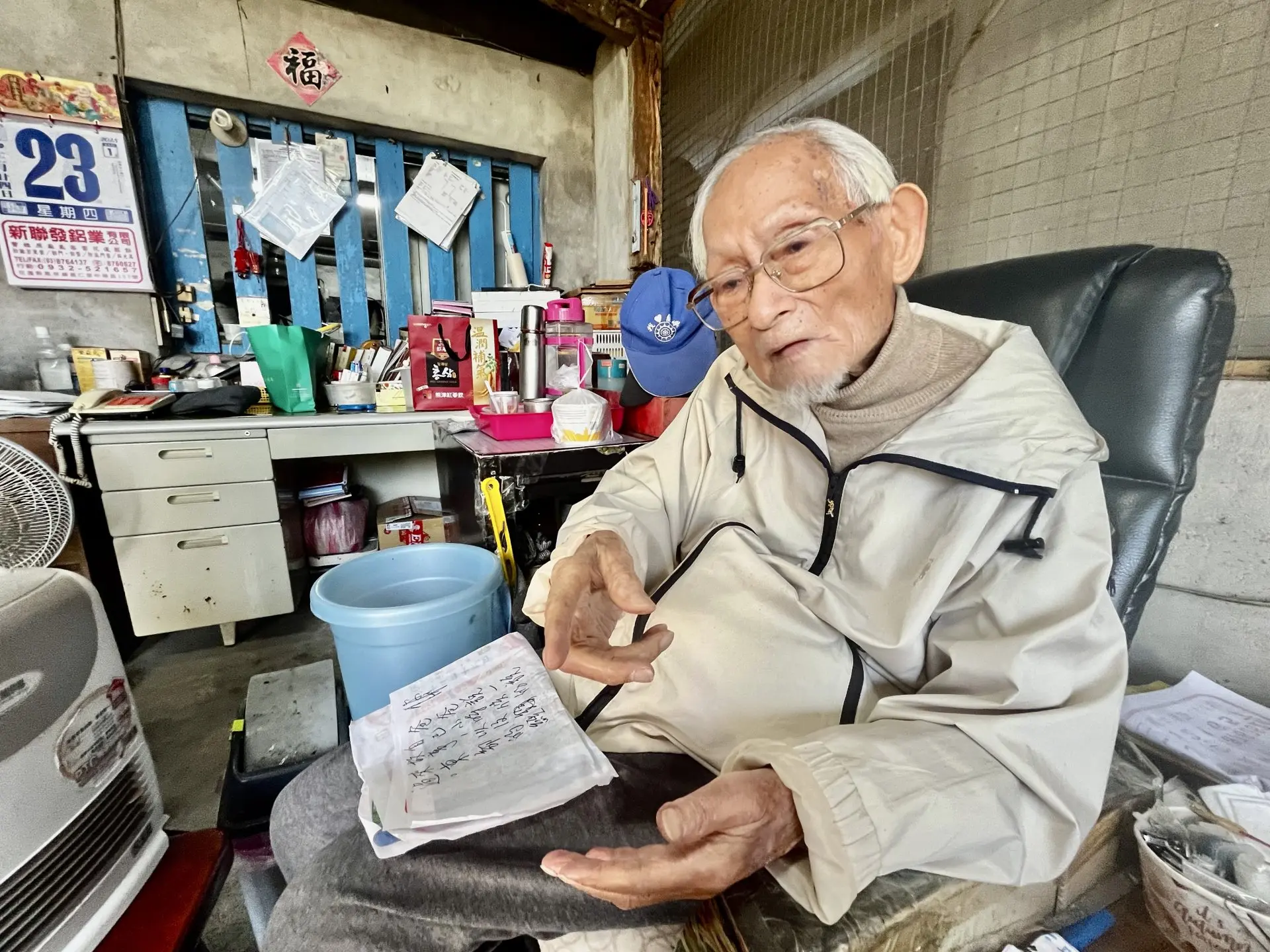 107歲的徐榕福老先生手握寫著問題的紙張,我們用筆談逐一提問。徐彩雲攝
